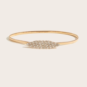 Detailed close-up of a gold elastic metal belt featuring a rhinestone-encrusted buckle