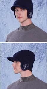 Close-up of winter knit baseball cap with ear flaps and snowflake embroidery detail