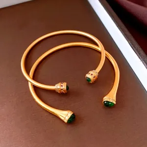 Vintage style gold open bangles with green zircons and textured matte finish for women