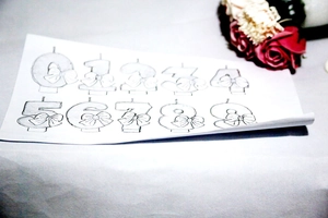 Line drawing of number birthday candles 0-9 with cute bows for party decoration