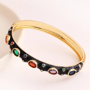 Vintage gold-plated bangle with black enamel and multi-colored cubic zirconia stones