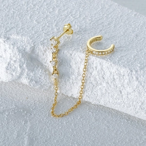 Macro shot of gold S925 sterling silver ear cuff with cubic zirconia and chain link