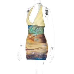 Detail of crochet halter neck top and multi-color abstract print mini dress on mannequin