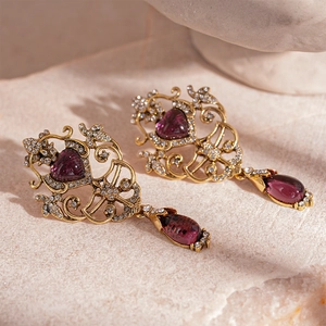 Vintage Baroque gold earrings with purple heart gems and sparkling rhinestone accents