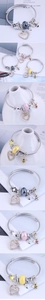 Detail of silver wire braided bracelet featuring heart, bee charms and colorful glass beads