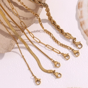 Detail of 18K gold plated Figaro and snake chain bracelets with lobster clasp closures