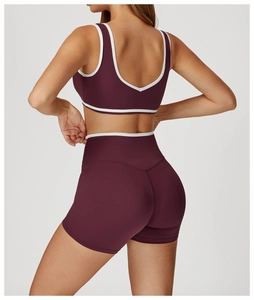 Rear view of deep purple crossover yoga set with white contrast piping detail