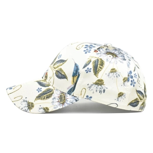 Close-up of stylish baseball cap with intricate floral and bird patterns on cream fabric