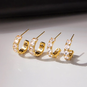 Set of two gold-plated C-shaped hoop earrings with square and round cubic zirconia stones