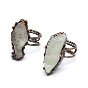 Detail of handcrafted copper wire ring with raw green translucent agate geode stone