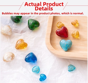 Macro shot of colorful heart-shaped glass beads with gold leaf for DIY jewelry