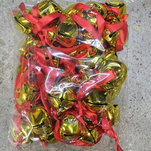 Bulk gold metal Christmas bells with Believe engraving and red ribbons in clear bag