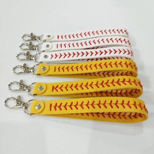Detail of baseball and softball leather wristlets with red stitching and silver lobster claws