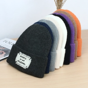 Winter knitted beanie collection with embroidered patches and ribbed fabric in vibrant colors