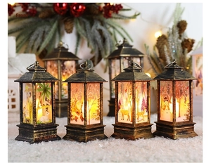 Detail of four Christmas lanterns with festive illustrations and warm LED lighting