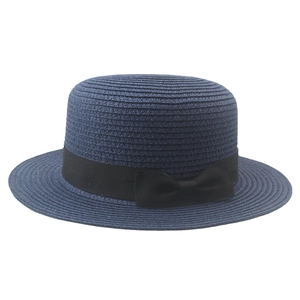 Detailed close-up of navy blue straw boater hat with black grosgrain ribbon and bow detail