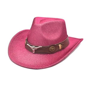 Detail of hot pink cowboy hat featuring a silver bull head emblem and leather band