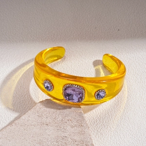 Detailed macro view of retro resin cuff bracelet with purple gemstones and crystals