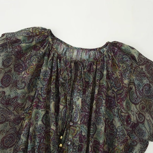 Women's paisley print mini dress with metallic threads and beaded tie neckline