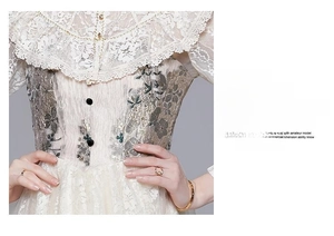 Detail of off-white lace dress featuring floral embroidery and ruffled collar accents