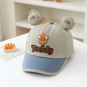 Close-up of baby teddy bear baseball cap with cute 3D ears and detailed embroidery