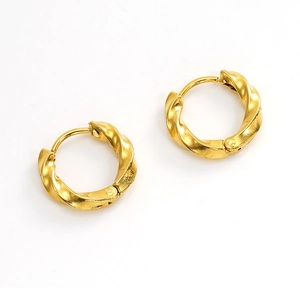 Detail of gold-plated stainless steel hoop earrings with a twisted spiral texture