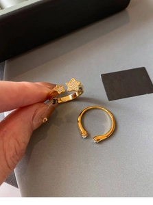Detail of gold-plated star rings with micro-set zircons on a minimalist adjustable band