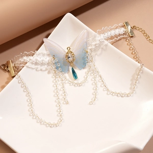 Detailed shot of white lace choker with blue butterfly, gemstone and crystal tassels
