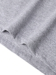 Detailed macro view of the double-stitched hem on grey knitted fabric of the t-shirt