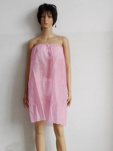 Detail of light pink disposable non-woven spa wrap robe with elastic chest band
