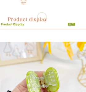 Detail of light green acetate hair claw clip showing natural marble texture and metal spring