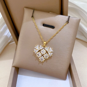 Close-up of heart pendant necklace with shimmering crystals on white silk background