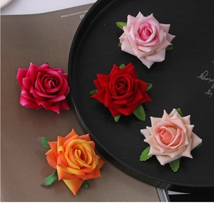 Detailed view of handmade silk rose flower heads in assorted colors for hair accessories