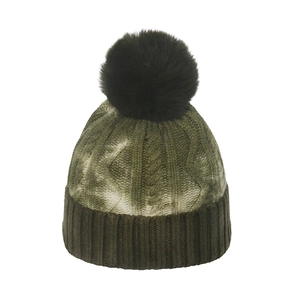 Detail of gradient knit beanie featuring dark faux fur pom-pom and ribbed cuff
