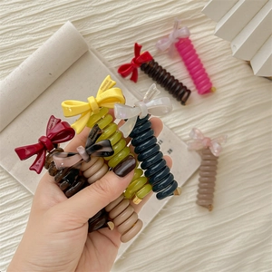 Spiral telephone wire hair ties with handmade bows in diverse pastel and earthy colors