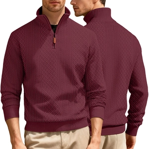 Detailed close-up of textured jacquard knit fabric and high-quality quarter zip stand collar