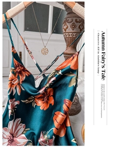 Detail of teal floral satin slip dress with cowl neck design and golden necklace