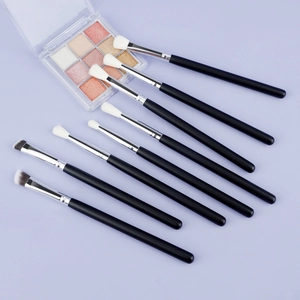 Macro shot of professional 8-piece eye makeup brush set with wooden handles and soft fibers