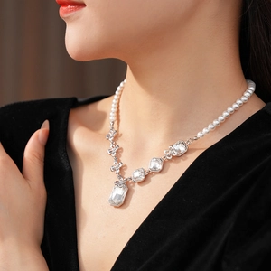 Close-up of pearl and crystal necklace with rectangular pendant on a female model