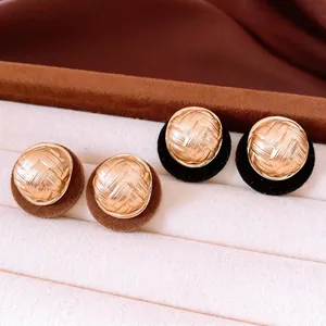 Vintage round stud earrings with gold woven texture and velvet backing in brown and black