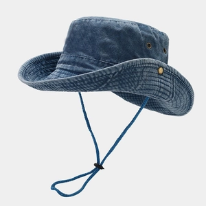 Detail of dark blue washed cotton bucket hat with adjustable chin cord and metal eyelets