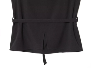 Detailed back view of a black belted vest with a center vent and textured fabric