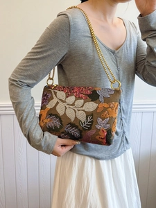 Elegant sequined evening clutch bag with floral embroidery and gold chain strap