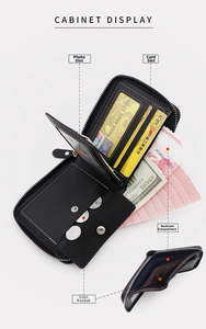 Detailed view of the black leather wallet interior featuring card slots and coin pocket