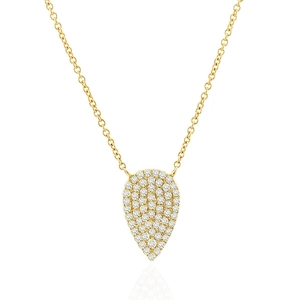 Macro detail of gold plated pear shaped pendant necklace with sparkling zircon pavé