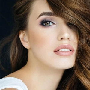 Minimalist round cubic zirconia stud earrings shown on model with professional lighting