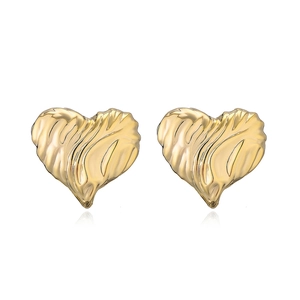 Macro shot of gold plated heart stud earrings with unique crumpled metal texture detail