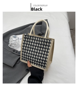 Detail of black and white checkered linen tote bag with cream rope handles