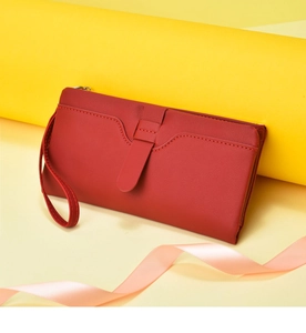 Red women's long wallet detail view, PU leather clutch purse with wrist strap and slots.