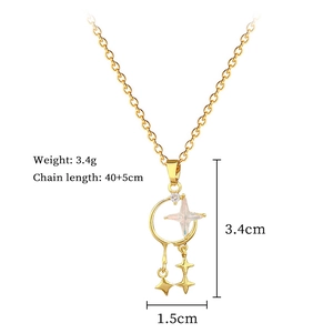 Macro shot of gold star moon pendant with cubic zirconia and opal on 40+5cm chain